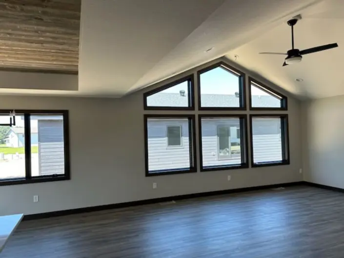 Spacious living room with vaulted ceiling and large windows in a Redi-Built home in South Dakota