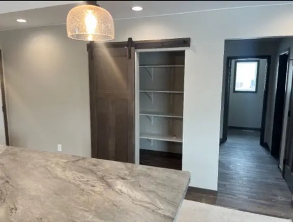 Redi-Built Home Pantry with Barn Door Walk-in pantry with sliding barn door in a custom Redi-Built home