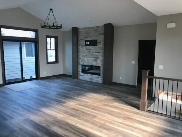 Custom Redi-Built home kitchen with dark wood cabinetry, large island and pendant lighting