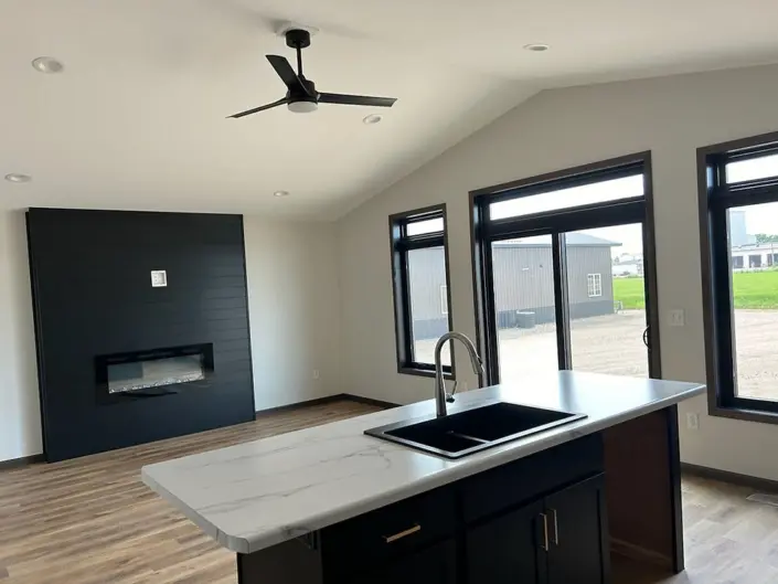 Custom Redi-Built home kitchen with dark cabinetry, large island and pendant lighting