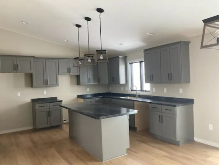 Custom kitchen with gray cabinets and large island in a Redi-Built home
